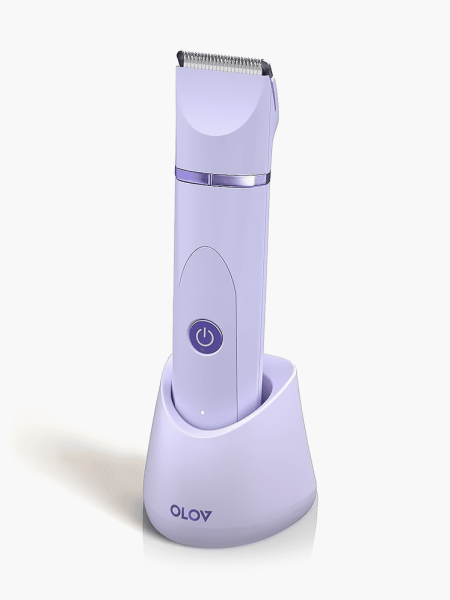 Electric Body Hair Trimmer in soft purple color way on matching stand on light gray background